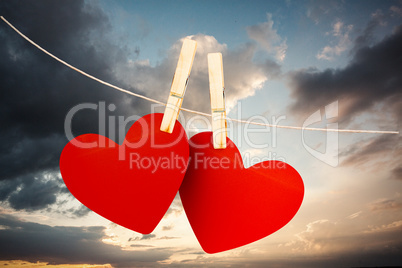 Composite image of hearts hanging on line