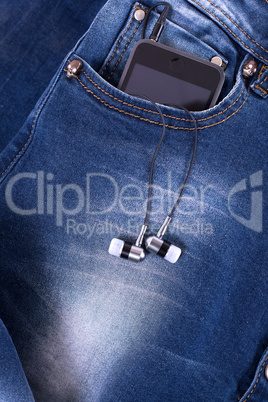 MP3 player and earphones sticking out of jeans pocket