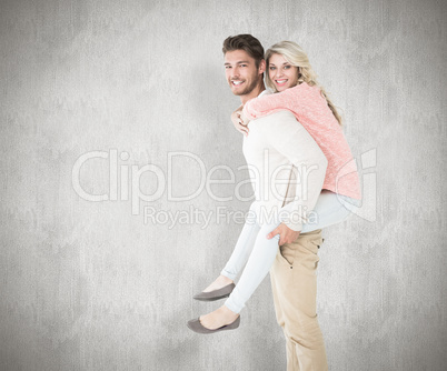 Composite image of handsome man giving piggy back to his girlfri