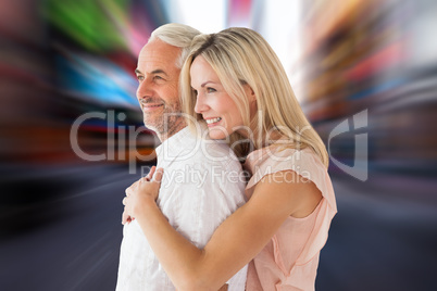 Composite image of affectionate couple standing and hugging