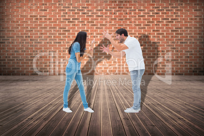 Composite image of angry couple shouting at each other