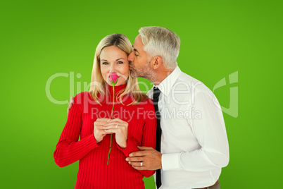 Composite image of handsome man giving his wife a kiss on cheek