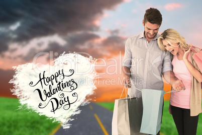 Composite image of attractive young couple holding shopping bags