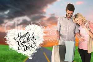 Composite image of attractive young couple holding shopping bags