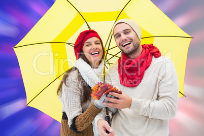 Composite image of autumn couple holding umbrella