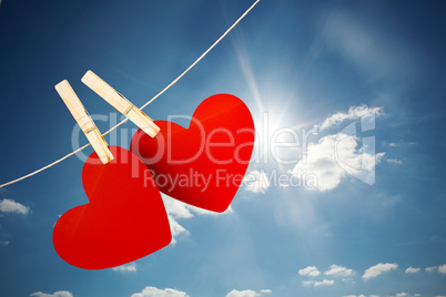 Composite image of hearts hanging on line