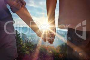 Composite image of couple holding hands in park