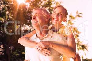 Happy senior man giving his partner a piggy back