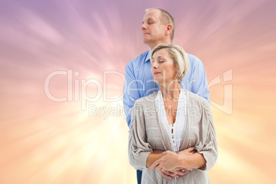 Composite image of happy mature couple embracing with eyes close