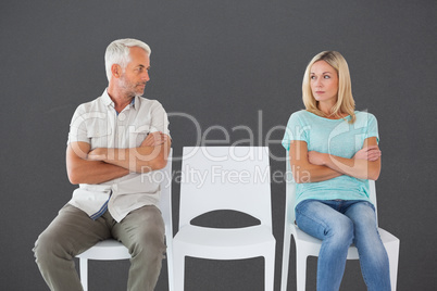 Composite image of unhappy couple not speaking to each other