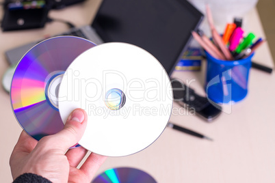 hand holding white blank CD DVD disk