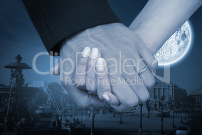 Composite image of newlyweds holding hands close up