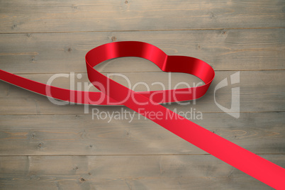 Large red ribbon in a heart shape