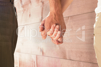 Composite image of happy senior couple holding hands Composite image of happy senior couple holding hands