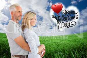 Composite image of happy couple smiling and embracing