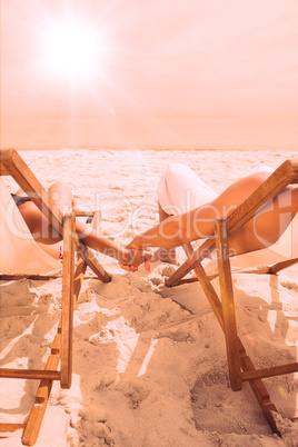 Cute couple lying on deck chairs