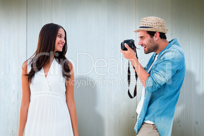 Composite image of handsome hipster taking a photo of pretty gir