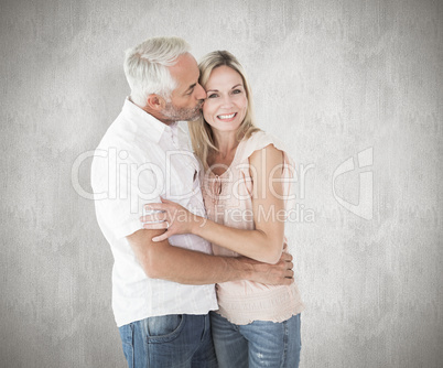 Composite image of affectionate man kissing his wife on the chee