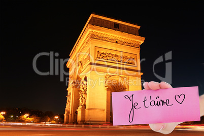 Composite image of hand holding card showing je taime