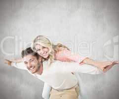 Composite image of handsome man giving piggy back to his girlfri