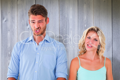 Composite image of young couple making silly faces