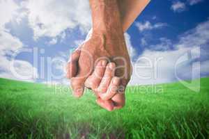 Composite image of happy senior couple holding hands