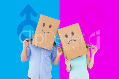 Composite image of couple wearing sad face boxes on their heads