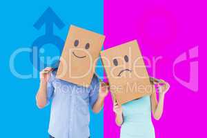 Composite image of couple wearing sad face boxes on their heads