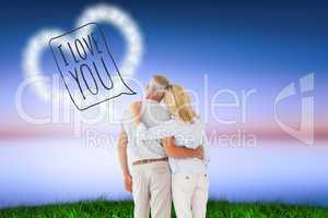 Composite image of happy couple standing and looking