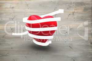 Composite image of love heart wrapped in ribbon