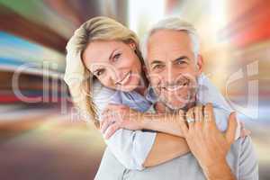 Composite image of happy couple standing and hugging