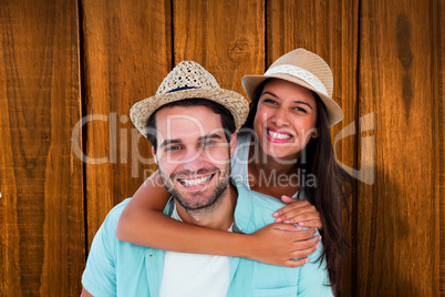 Composite image of happy casual man giving pretty girlfriend pig