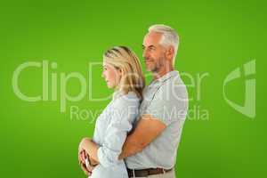 Composite image of happy couple smiling and embracing