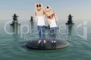 Composite image of mature couple wearing boxes over their heads
