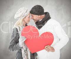 Composite image of smiling couple in winter fashion posing with