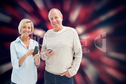 Composite image of happy mature couple using their smartphones