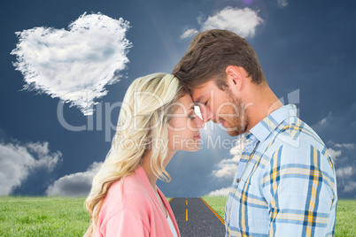 Composite image of attractive couple standing touching heads