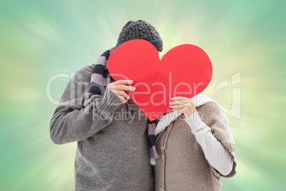 Composite image of happy mature couple in winter clothes holding