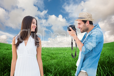 Composite image of handsome hipster taking a photo of pretty gir