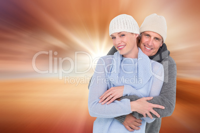 Composite image of casual couple in warm clothing