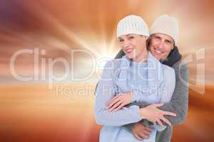 Composite image of casual couple in warm clothing