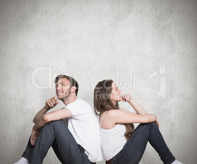 Composite image of young couple sitting on floor