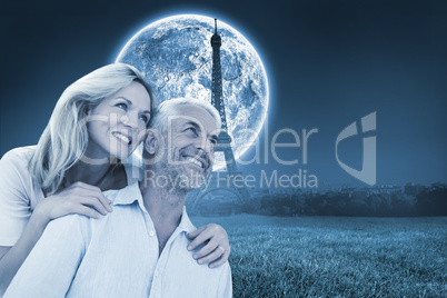 Composite image of smiling couple embracing and looking