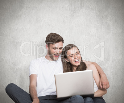 Composite image of young couple using laptop on floor Composite image of young couple using laptop on floor