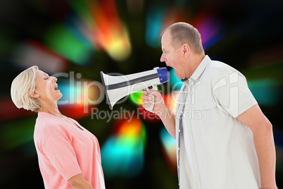 Composite image of man shouting at his partner through megaphone