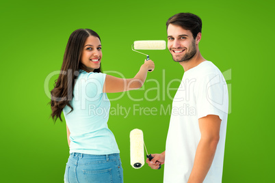 Composite image of happy young couple painting together