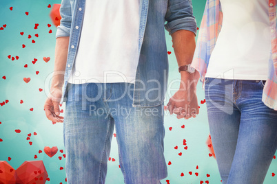 Composite image of hip young couple holding hands