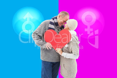 Composite image of happy mature couple in winter clothes holding