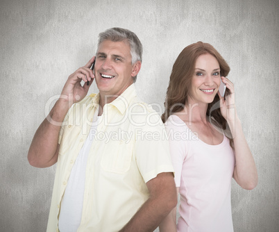 Composite image of casual couple on their phones