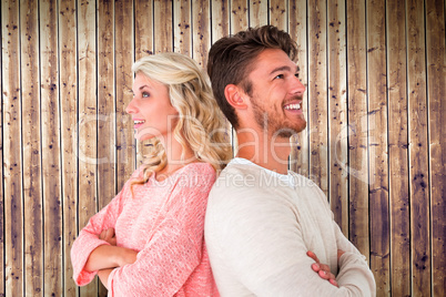 Composite image of attractive couple smiling with arms crossed